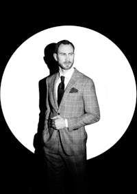 a black and white photo of a man in a suit