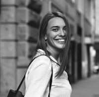 a black and white photo of a woman smiling